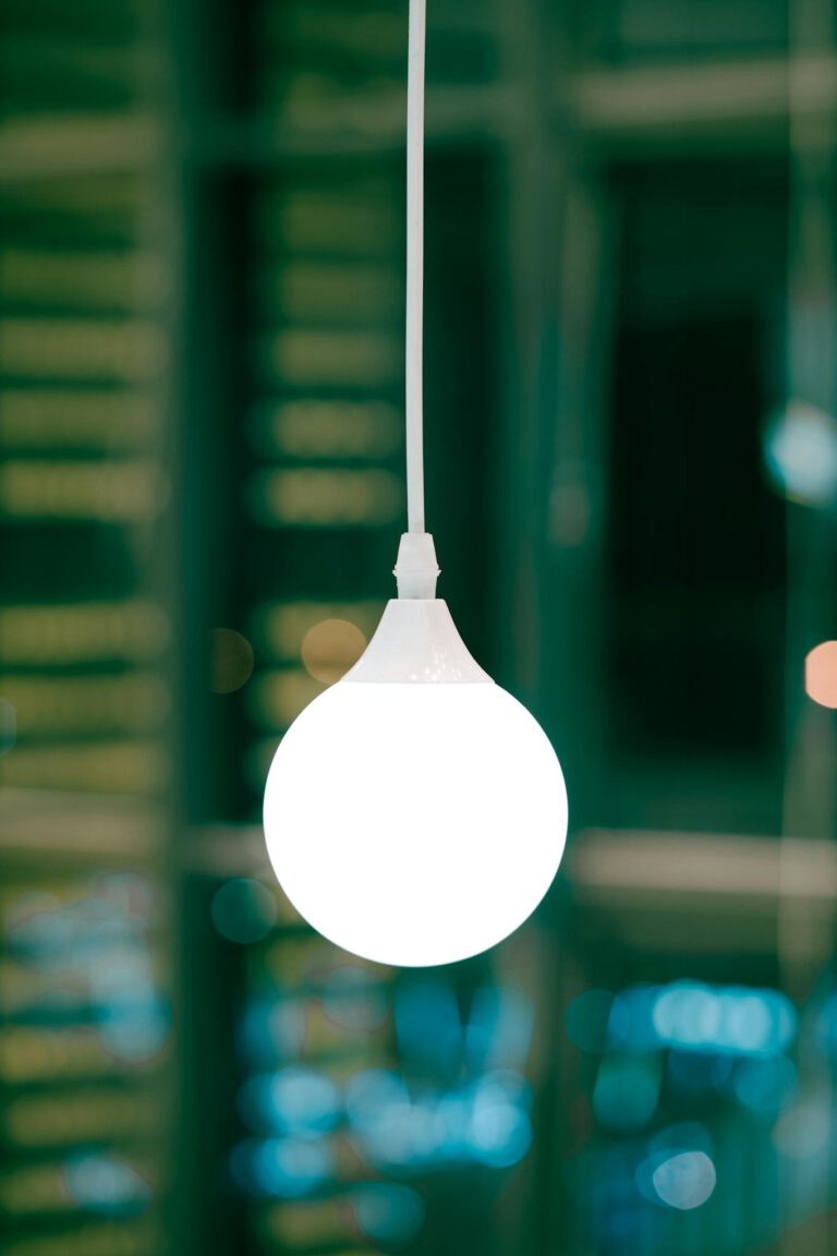 Close-up of a glowing white light bulb, modern ambiance.