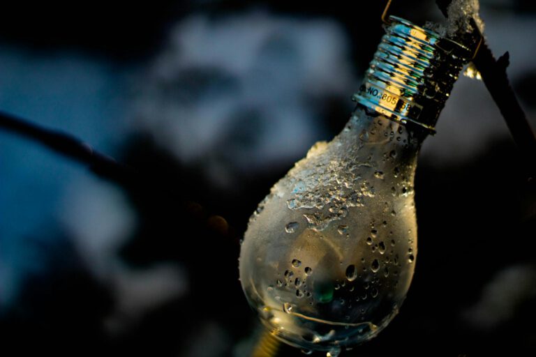 Detailed shot of a light bulb covered in water droplets and ice.